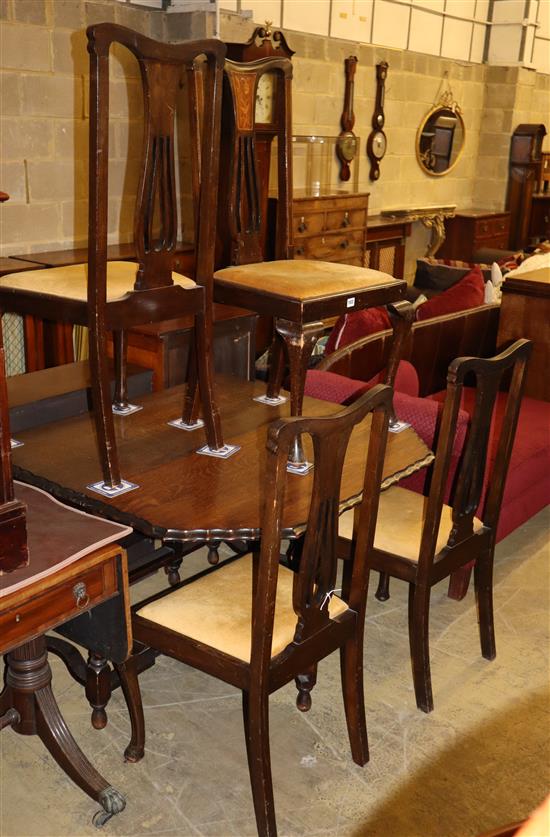 A 1920s oak gateleg dining table, W.150cm extended, together with a set of four Art Nouveau style beech dining chairs